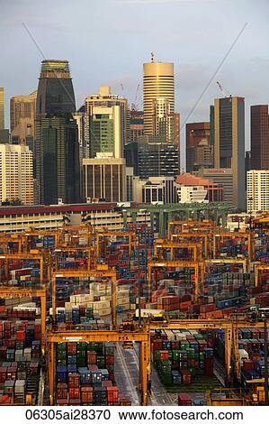 Stock Image - Singapore skyline with shipping containers in foreground. Fotosearch