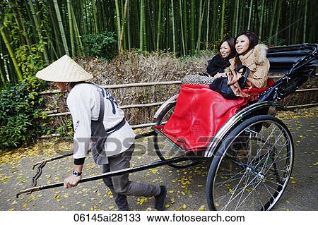 Two women riding in a rickshaw, Japan View Large Photo Image Stock Image - Two women riding in a rickshaw, Japan. Fotosearch