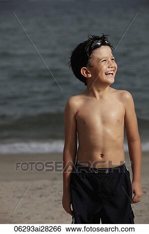 Young boy looking up and laughing with goggles on his head View Large Photo Image Stock Photograph - Young boy looking up and laughing with goggles on his head. Fotosearch