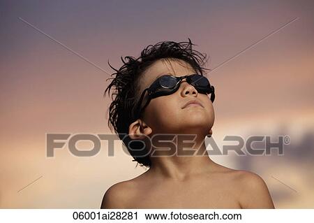 young boy looking up with goggles on at sunset View Large Photo Image Stock Image - young boy looking up with goggles on at sunset. Fotosearch