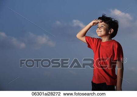 Young boy wearing a red shirt looking out with hand shielding eyes View Large Photo Image Stock Image - Young boy wearing a red shirt looking out with hand shielding eyes. Fotosearch