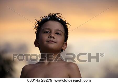 Young boy with goggles on his head at sunset. View Large Photo Image Stock Photo - Young boy with goggles on his head at sunset.. Fotosearch