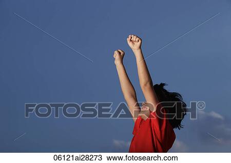 Stock Image - Young boy with red shirt with hands outstretched. Fotosearch