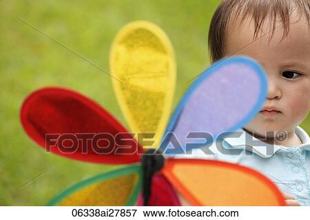 young girl looking at toy flower View Large Photo Image Stock Photo - young girl looking at toy flower. Fotosearch