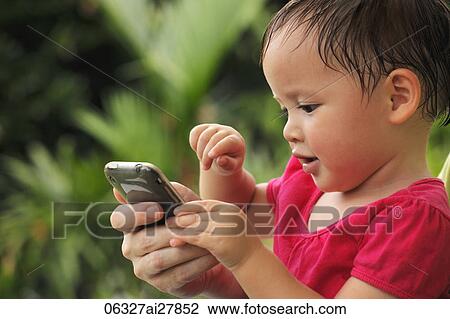 young girl playing with phone View Large Photo Image Stock Image - young girl playing with phone. Fotosearch