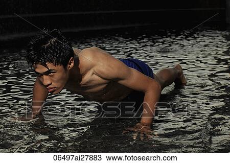 young man doing push ups in water View Large Photo Image Stock Image - young man doing push ups in water. Fotosearch
