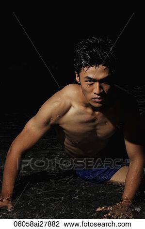 Young man sitting in water View Large Photo Image Stock Image - Young man sitting in water. Fotosearch