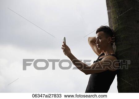 young man taking a photo with phone. View Large Photo Image Stock Image - young man taking a photo with phone.. Fotosearch