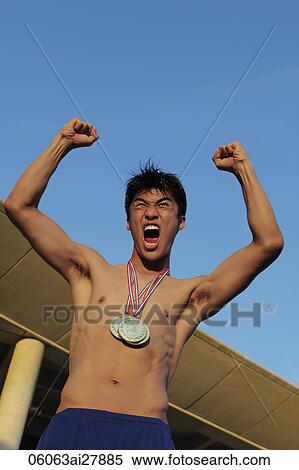 Young man wearing gold medals and shouting with hands in air View Large Photo Image Stock Photography - Young man wearing gold medals and shouting with hands in air. Fotosearch