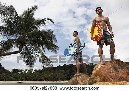 young men holding skim boards looking out to ocean View Large Photo Image Stock Photo - young men holding skim boards looking out to ocean. Fotosearch
