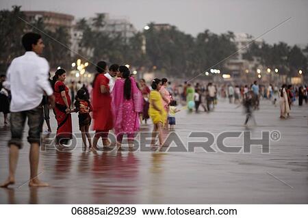 A crowd of people walking along the beach in Mumbai, India View Large Photo Image Stock Photo - A crowd of people walking along the beach in Mumbai, India. Fotosearch