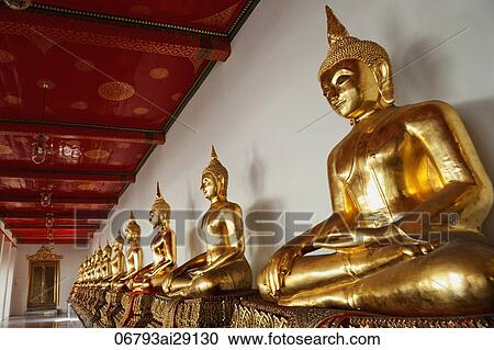 Stock Image - A row of Buddha statues at Wat Pho, Bangkok, Thailand. Fotosearch