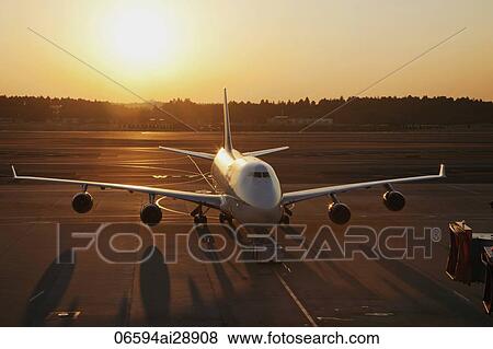 Airplane on tarmac, sun behind. Narita Airport, Japan View Large Photo Image Stock Photo - Airplane on tarmac, sun behind. Narita Airport, Japan. Fotosearch
