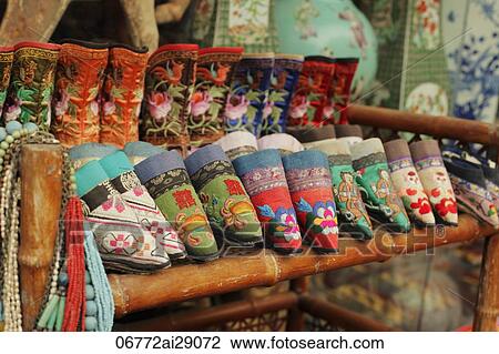 Stock Image - Antique shoes for Women's bound feet for sale in Chinese market. Fotosearch
