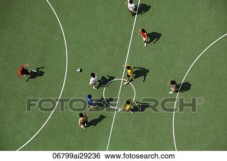Stock Photograph - Arial view of men playing soccar. Fotosearch