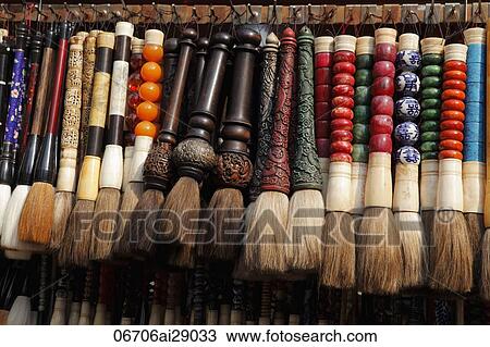 Stock Image - Chinese brushes hanging in a row, market, China. Fotosearch