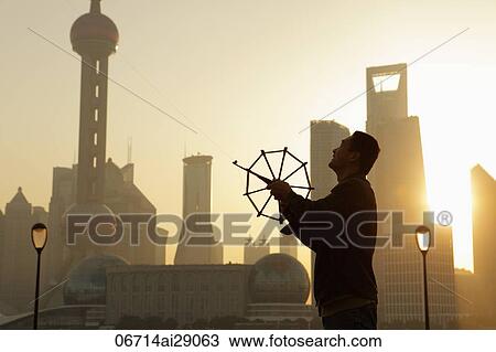 Chinese man flying kite on the Bund, Shanghai, China View Large Photo Image Stock Image - Chinese man flying kite on the Bund, Shanghai, China. Fotosearch