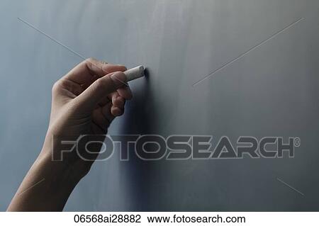 Close up of hand holding piece of chalk on chalkboard View Large Photo Image Stock Image - Close up of hand holding piece of chalk on chalkboard. Fotosearch