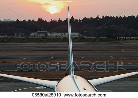 Close up of tail of airplane with the sun behind, Narita Airport, Japan View Large Photo Image Stock Image - Close up of tail of airplane with the sun behind, Narita Airport, Japan. Fotosearch