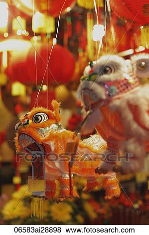 Stock Photo - Close up of toy dragons hanging in market.. Fotosearch