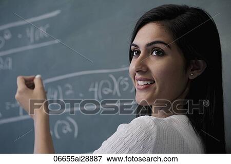 Close up of woman writing on chalk board and smiling View Large Photo Image Stock Photo - Close up of woman writing on chalk board and smiling. Fotosearch
