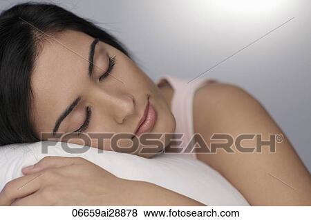 Close up of young woman sleeping on pillow View Large Photo Image Stock Photo - Close up of young woman sleeping on pillow. Fotosearch