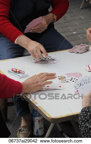 Closeup of woman playing cards on the street in China View Large Photo Image Stock Image - Closeup of woman playing cards on the street in China. Fotosearch