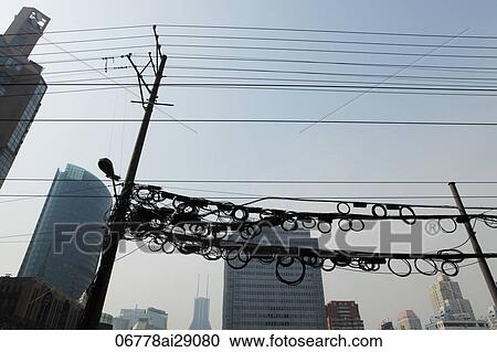 Stock Image - Coiled electrical wires above the street. Shanghai, China. Fotosearch