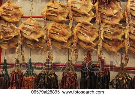 Stock Photography - Dried duck and sausages hanging in a market. Fotosearch