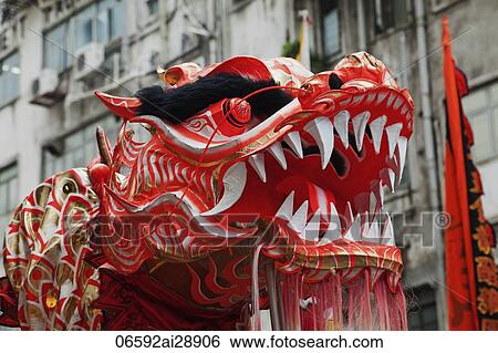 Stock Photograph - Head of dragon during traditional Dragon Dance. Tai Kok Tsui Temple Fair. Hong Kong, China. Fotosearch