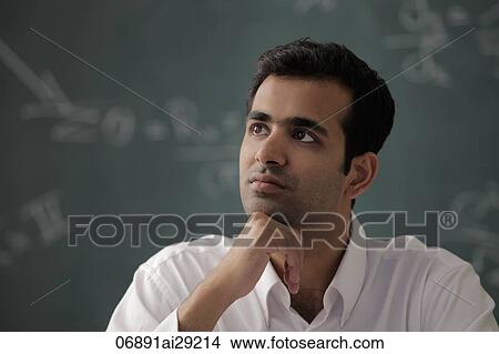 Head shot of young man with hand on his chin looking up View Large Photo Image Picture - Head shot of young man with hand on his chin looking up. Fotosearch