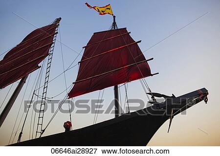 Stock Photo - Junk Boat sailing in Victoria Harbour. Hong Kong, China. Fotosearch