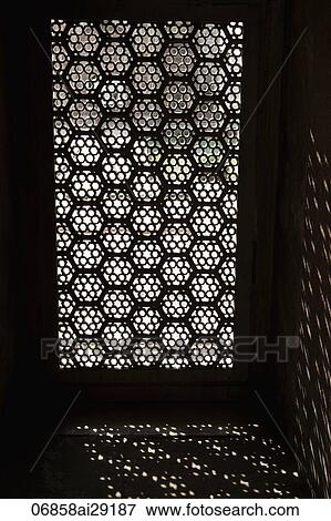 Light coming through a carved screen window. Agra, India View Large Photo Image Stock Photo - Light coming through a carved screen window. Agra, India. Fotosearch