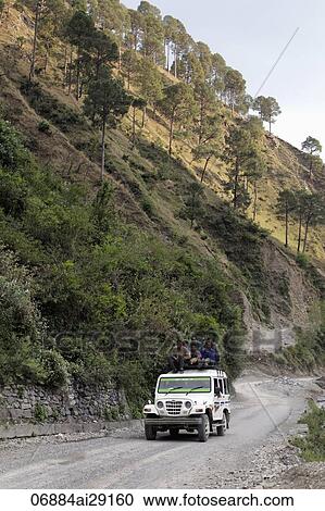 Men riding on the roof of a truck through the Himalayan Mountains, India View Large Photo Image Stock Image - Men riding on the roof of a truck through the Himalayan Mountains, India. Fotosearch