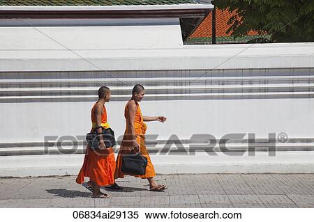 Monks walking along street in Bangkok, Thailand View Large Photo Image Stock Photography - Monks walking along street in Bangkok, Thailand. Fotosearch