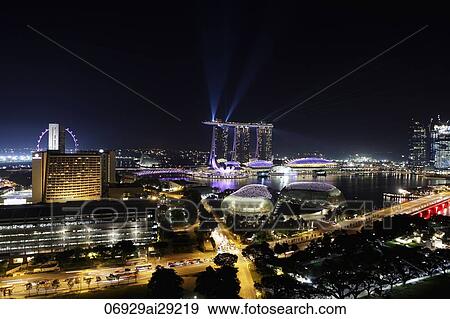 Night view of buildings surrounding Marina Bay with lasers off the Sands Casino, Singapore View Large Photo Image Stock Photo - Night view of buildings surrounding Marina Bay with lasers off the Sands Casino, Singapore. Fotosearch