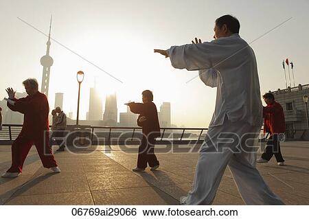 People doing Tai Chi on the bund in the morning, Shanghai, China View Large Photo Image Stock Photograph - People doing Tai Chi on the bund in the morning, Shanghai, China. Fotosearch