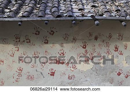 Picture - Red hand prints on side of village wall. New Delhi, India. Fotosearch