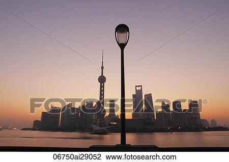 Shanghai skyline at sunrise, lamp in foreground View Large Photo Image Stock Image - Shanghai skyline at sunrise, lamp in foreground. Fotosearch