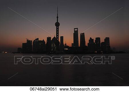 Stock Image - Silhouette of Shanghai skyline at sunset, China. Fotosearch