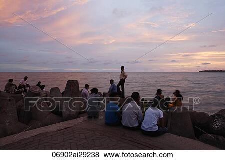 Small crowd gathered at the sea shore at sunset, Mumbai, India View Large Photo Image Stock Photo - Small crowd gathered at the sea shore at sunset, Mumbai, India. Fotosearch
