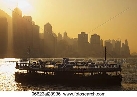 Stock Photograph - Star Ferry and City Skyline at Dawn, Hong Kong, China. Fotosearch
