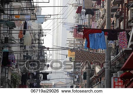 Street view of laundry hanging out of windows, Shanghai, China View Large Photo Image Stock Photograph - Street view of laundry hanging out of windows, Shanghai, China. Fotosearch