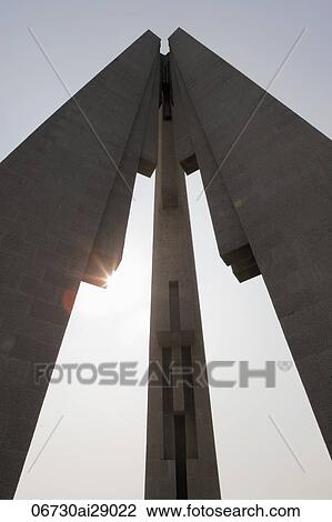 Stock Image - Sun burst behind arches of Peoples Heroes War Memorial, Shanghai, China. Fotosearch