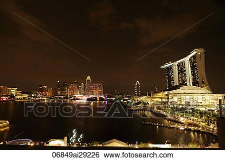 View of the buildings surrounding Marina Bay at night, Singapore View Large Photo Image Stock Photograph - View of the buildings surrounding Marina Bay at night, Singapore. Fotosearch