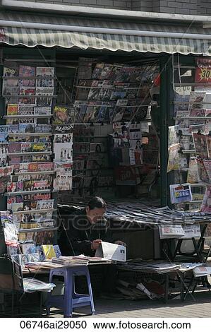 Woman selling magazines in a street stall, Shanghai, China View Large Photo Image Stock Image - Woman selling magazines in a street stall, Shanghai, China. Fotosearch