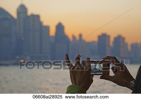 Woman Taking Photo of City Skyline and Victoria Peak. Hong Kong, China View Large Photo Image Stock Photography - Woman Taking Photo of City Skyline and Victoria Peak. Hong Kong, China. Fotosearch