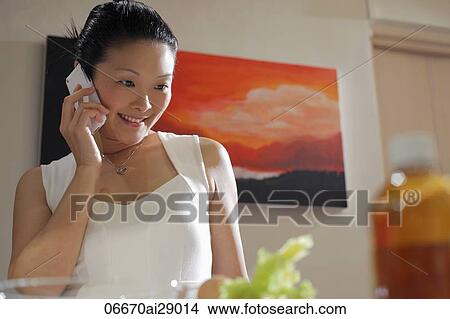 Woman talking on phone and smiling View Large Photo Image Picture - Woman talking on phone and smiling. Fotosearch