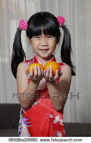 Young Chinese Girl Holding Oranges For Chinese New Year Stock