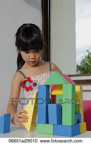 Stock Image - Young girl playing with blocks. Fotosearch